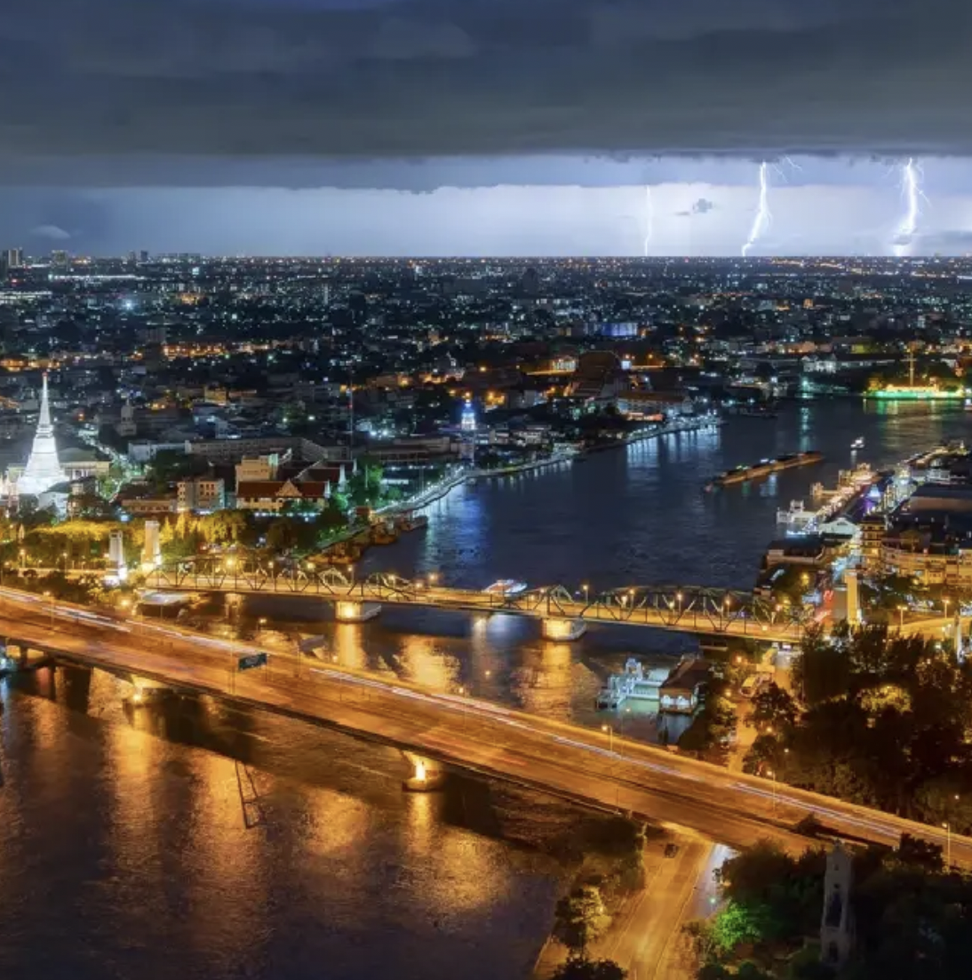 Heavy monsoon rain clouds over Thailand with flooding streets, rough seas, and stormy weather affecting Bangkok, Phuket, Krabi, and coastal regions during the 2026 rainy season